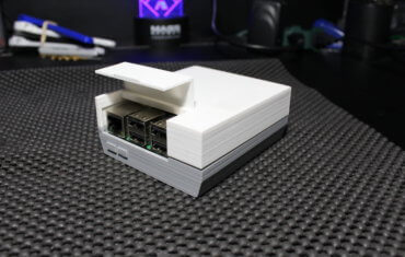 Ethernet and USB ports of Raspberry Pi Model 3B+ Retropie Gaming Console mounted inside of 2-part BabyNES case 3D printed out of white and gray PLA