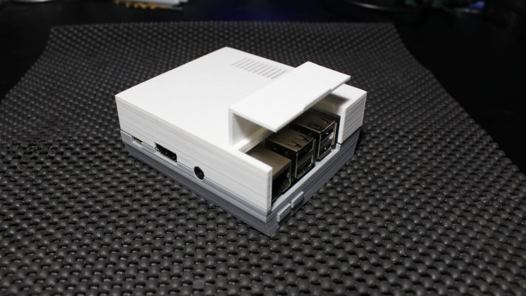 Micro USB, HDMI and 3.5mm Headphone ports of Raspberry Pi Model 3B+ mounted inside of 2-part BabyNES case 3D printed out of white and gray PLA