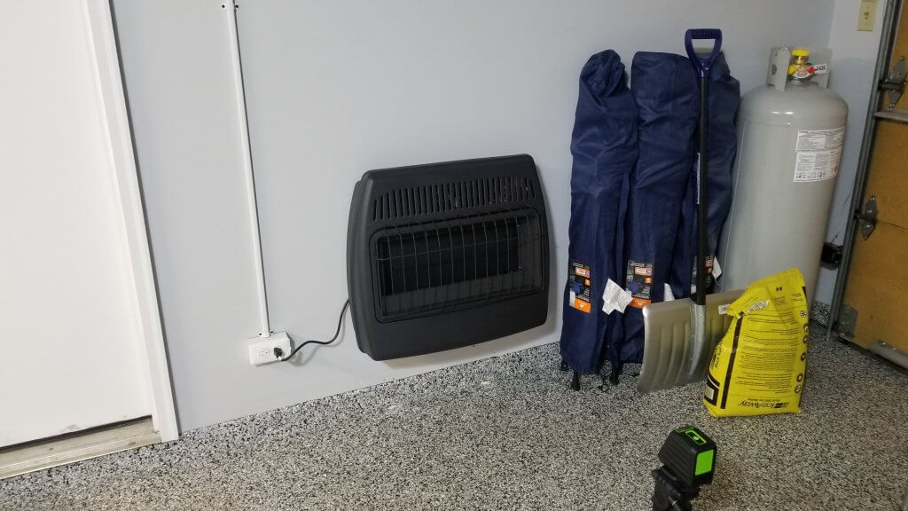 Propane fueled wall heater mounted in the rear of the garage, shown with 100 pound tank connected post remodeled.