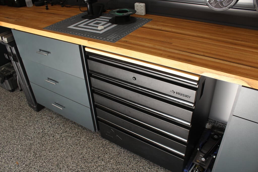 5-Drawer Husky tool chest for makerspace shown mounted underneath the shop workbench and in-between lower cabinet set.