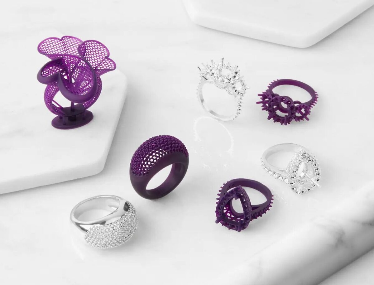 Several models of bespoke jewelry are shown sitting next to the finalized, precious-metal cast versions of themselves. The 3D printed objects are made out of Formlabs Castable Wax Resin.